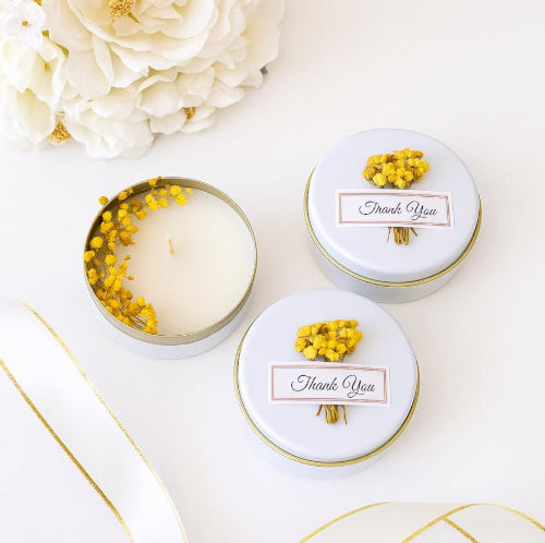 Scented candles with yellow dried flowers