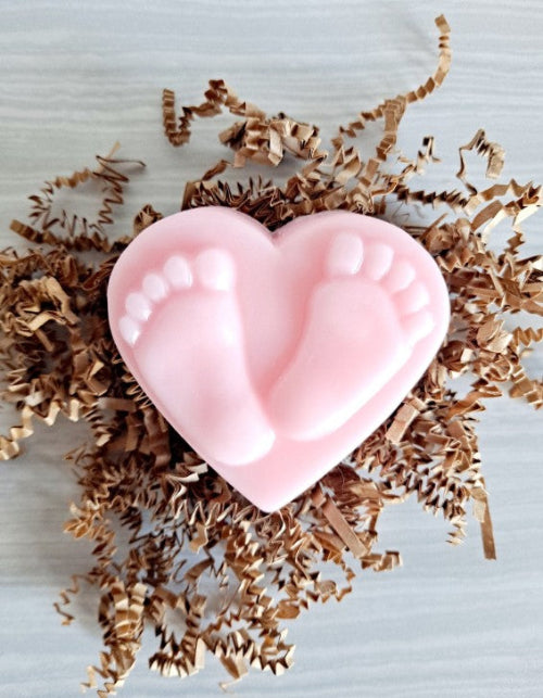 Heart-shaped pink soap on decorative paper