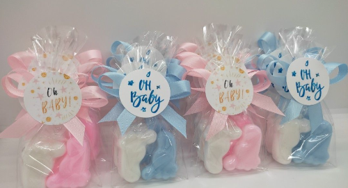 Set of baby shower favors with pink and blue ribbons and 'Oh Baby' labels.