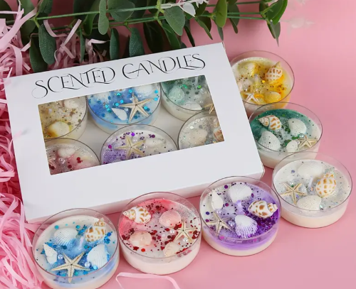 Set of scented candles with decorative elements in a box 