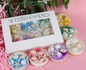 Set of scented candles with decorative elements in a box 