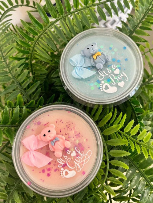 Two small containers with teddy bear scented candles , one pink and one blue, 